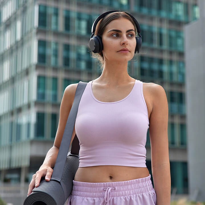 Woman walking with yoga mat